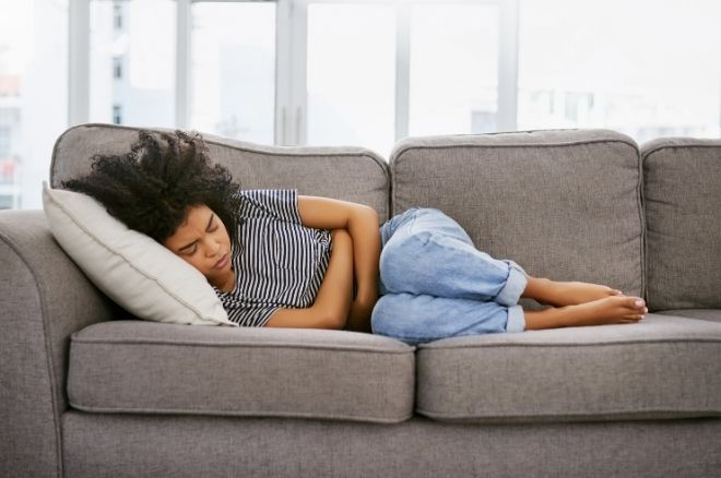 woman curled up on couch